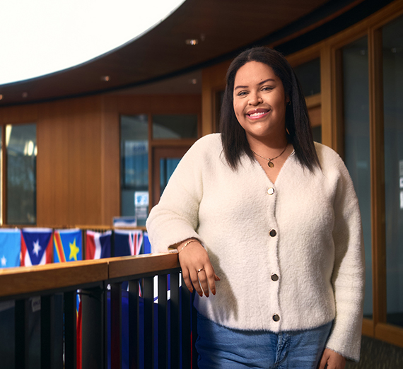 A woman jumps and cheers in a crowd of students